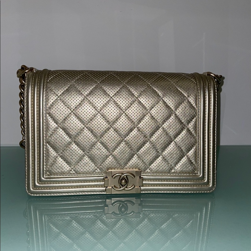 CHANEL Caviar Quilted Boy Flap in Metallic Gold.
